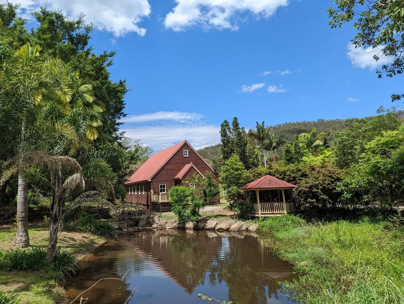 Open riverside lawns and shady trees at Historic Rivermill