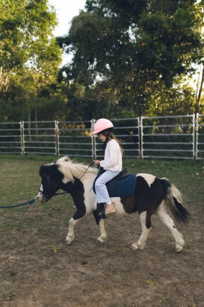 A young rider fist-bumping our guide from the saddle of a pony